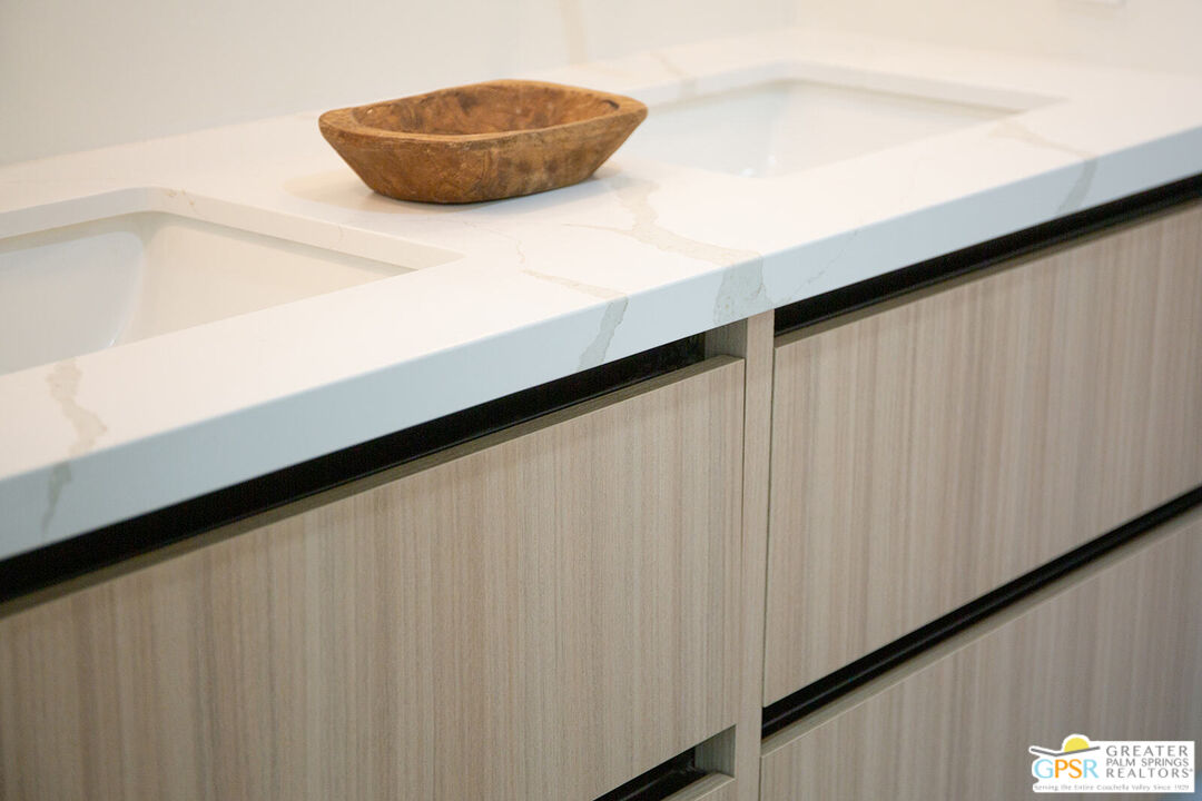 48940 Desert Flower Drive Palm Desert, CA 92260 - Photo 21 of 31 a kitchen with a white wall and a large window