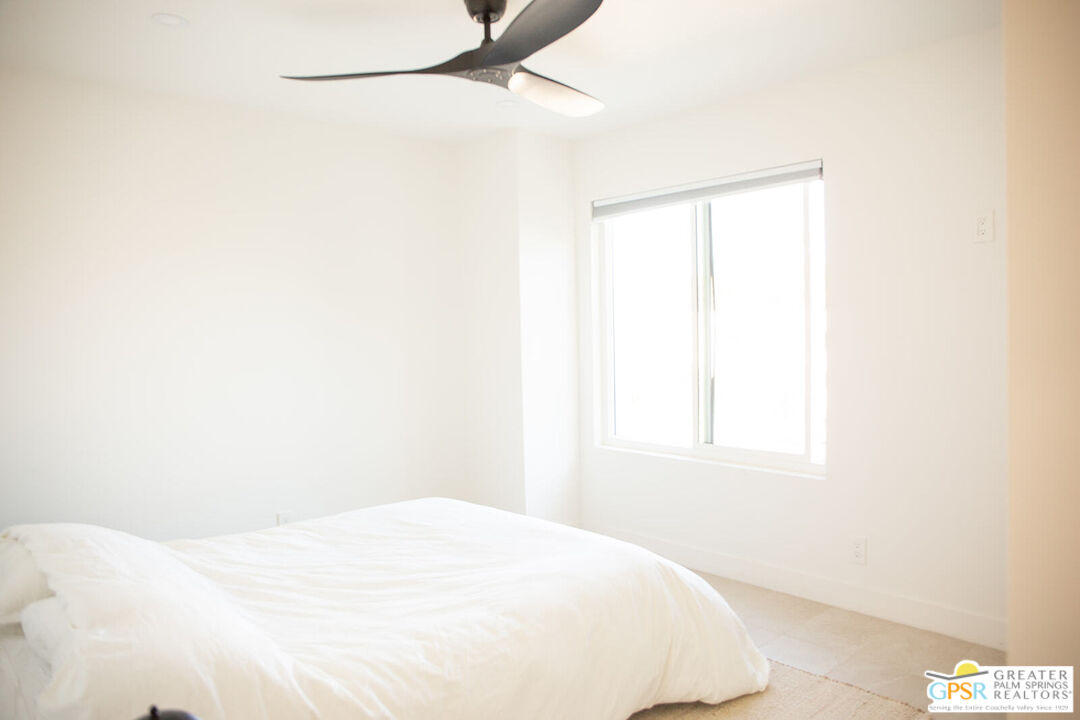 48940 Desert Flower Drive Palm Desert, CA 92260 - Photo 23 of 31 a bedroom with a bed and a window