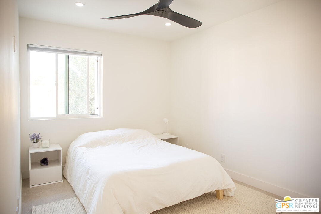 48940 Desert Flower Drive Palm Desert, CA 92260 - Photo 26 of 31 a bedroom with a bed and a window