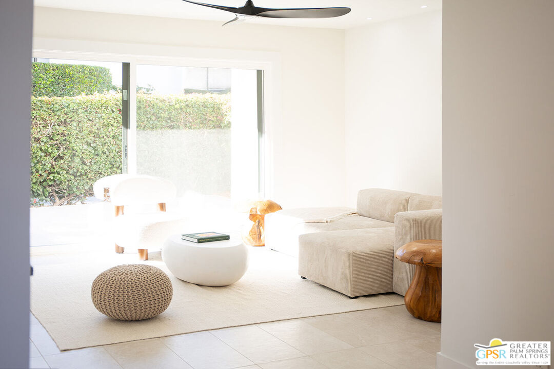 48940 Desert Flower Drive Palm Desert, CA 92260 - Photo 7 of 31 a living room with furniture and a window