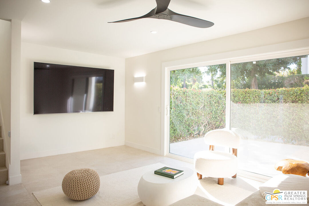 48940 Desert Flower Drive Palm Desert, CA 92260 - Photo 8 of 31 a living room with a large window and a couch