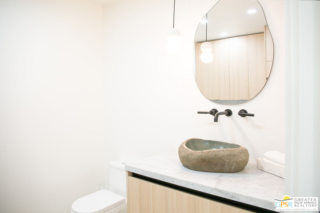 48940 Desert Flower Drive Palm Desert, CA 92260 - Photo 10 of 31 a bathroom with a sink and a mirror