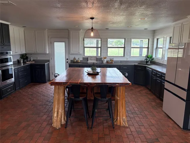 a kitchen with a dining table and chairs