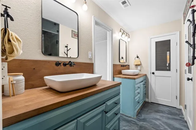 a bathroom with a double vanity sink and a mirror