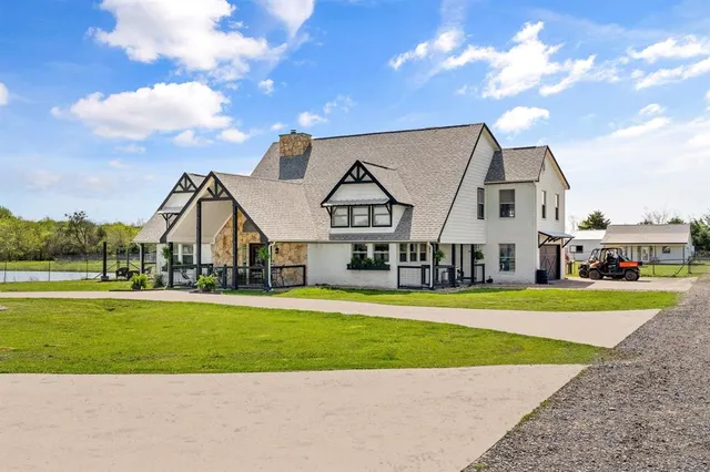 a view of a big house in a big yard with large trees