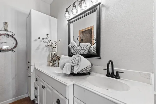 a bathroom with a sink a mirror and a toilet
