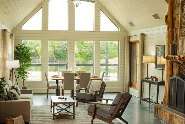 a living room with furniture and a floor to ceiling window