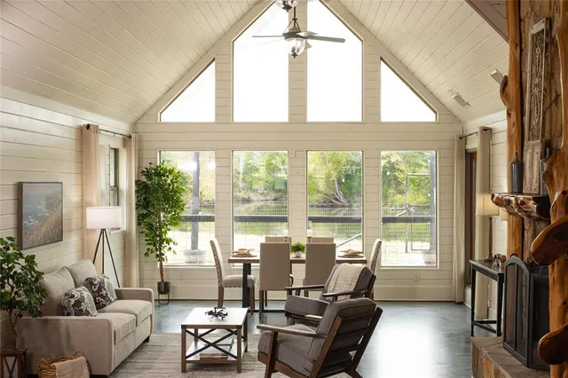 a living room with furniture and floor to ceiling windows