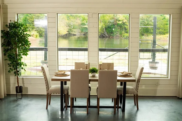 a view of a dining room with furniture and window