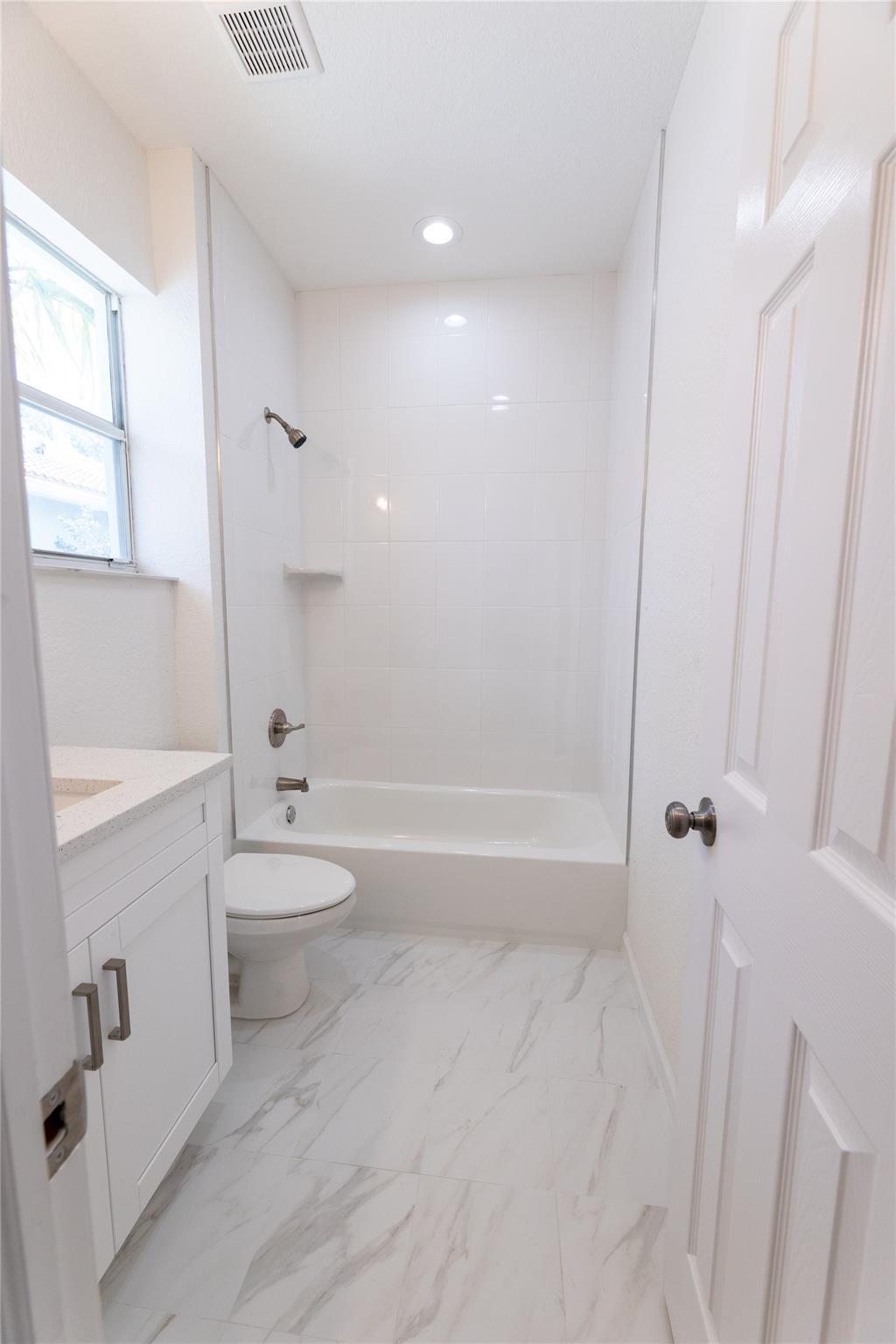 3199 Laurel Ridge Circle, Unit 3199 Riviera Beach, FL 33404 - Photo 15 of 44 a bathroom with a toilet and a bathtub