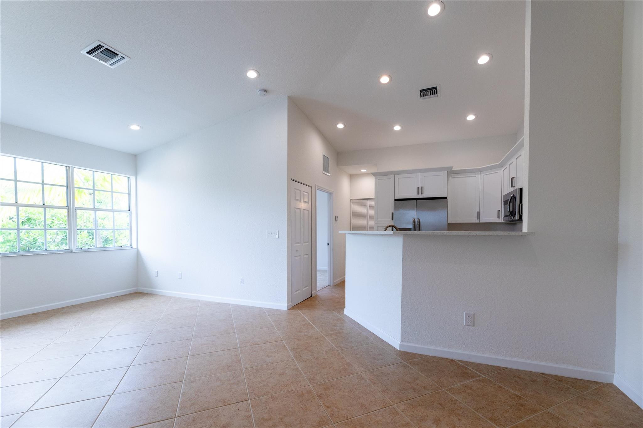 3199 Laurel Ridge Circle, Unit 3199 Riviera Beach, FL 33404 - Photo 25 of 44 a view of kitchen with kitchen island and stainless steel appliances