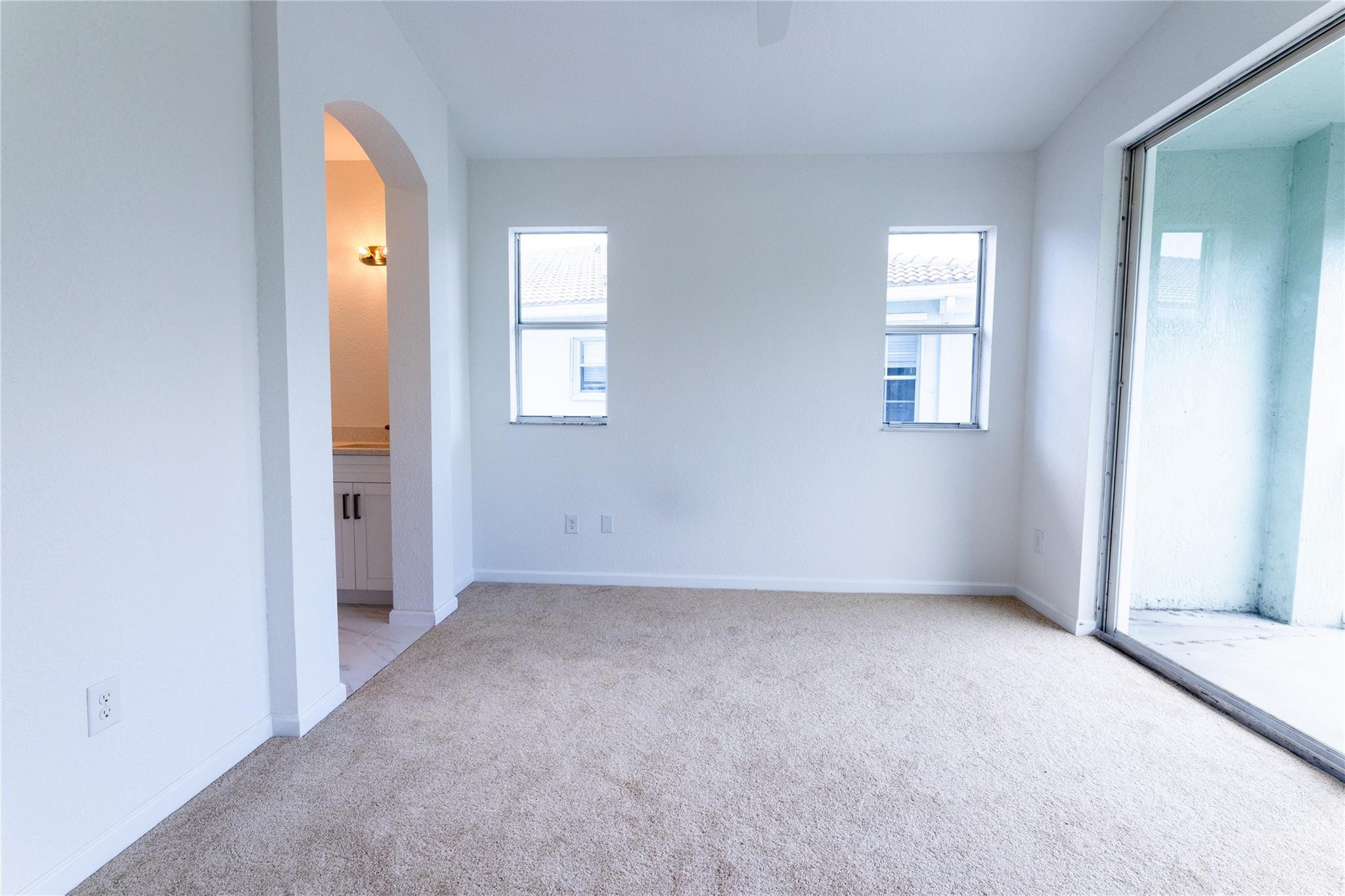 3199 Laurel Ridge Circle, Unit 3199 Riviera Beach, FL 33404 - Photo 27 of 44 an empty room with windows and closet