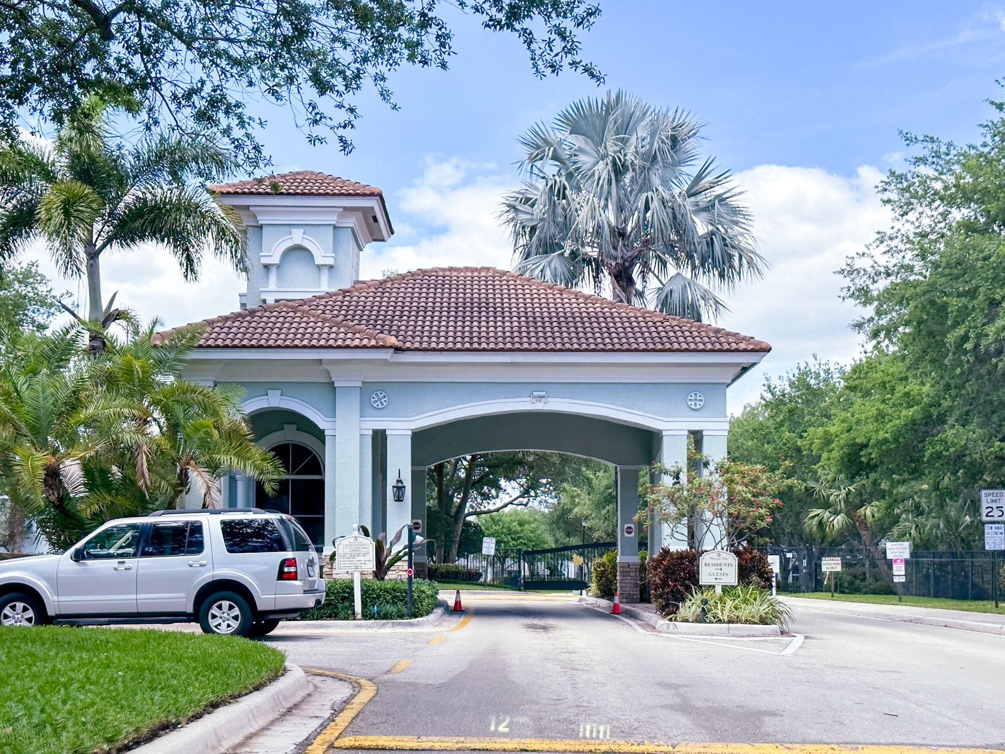 3199 Laurel Ridge Circle, Unit 3199 Riviera Beach, FL 33404 - Photo 35 of 44 a view of a car parked in front of a house