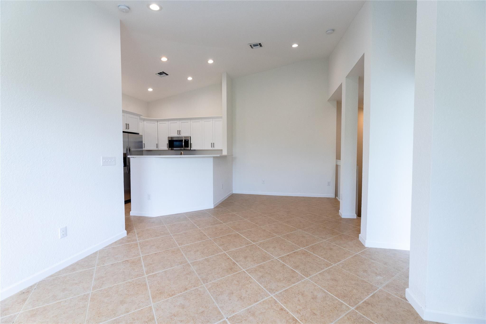 3199 Laurel Ridge Circle, Unit 3199 Riviera Beach, FL 33404 - Photo 5 of 44 a view of a kitchen with a sink and a refrigerator