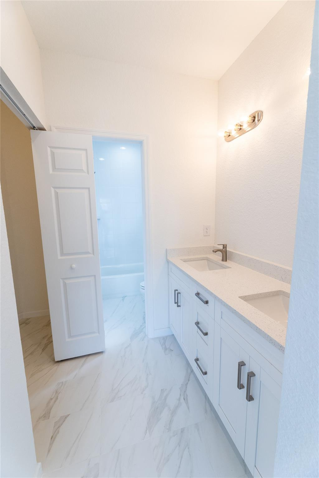 3199 Laurel Ridge Circle, Unit 3199 Riviera Beach, FL 33404 - Photo 9 of 44 a bathroom with a double vanity sink and mirror