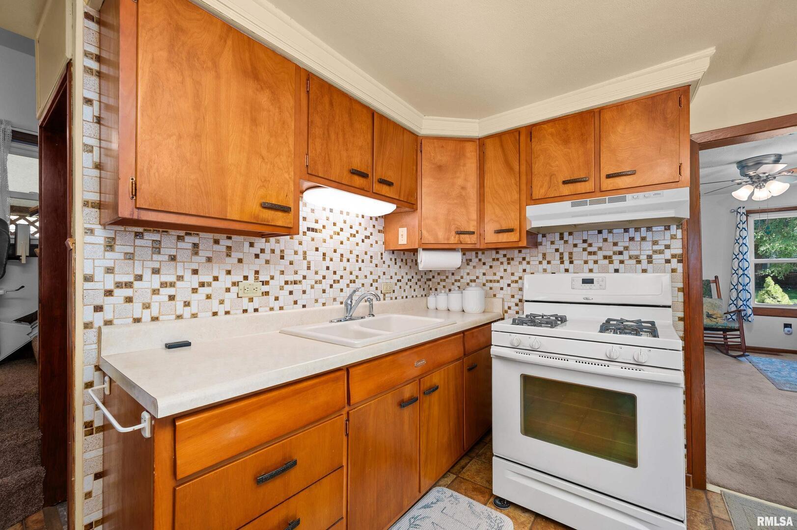 2375 31st Street, Unit A Moline, IL 61265 - Photo 11 of 26 a kitchen with granite countertop cabinets and white appliances