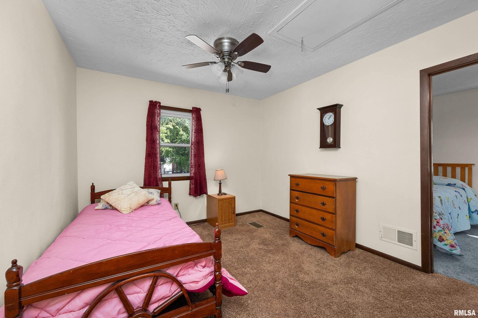 2375 31st Street, Unit A Moline, IL 61265 - Photo 15 of 26 a bedroom with a bed and a chandelier