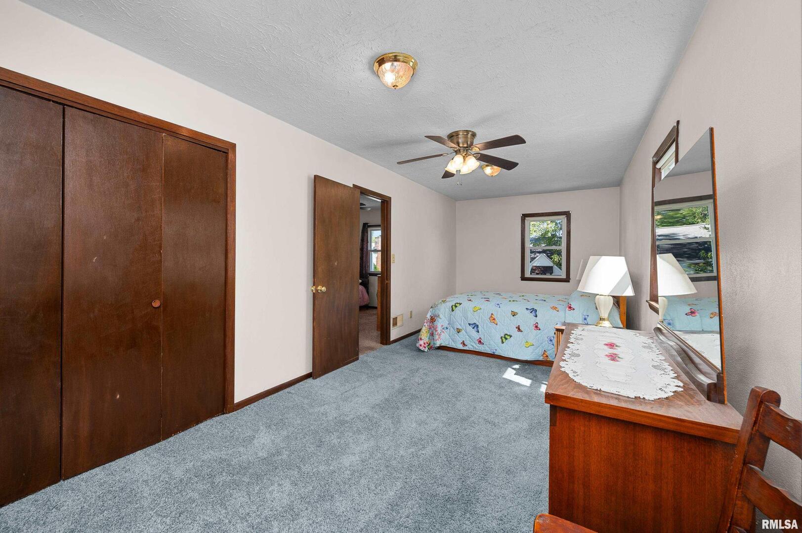 2375 31st Street, Unit A Moline, IL 61265 - Photo 19 of 26 a bedroom with a bed and a chandelier