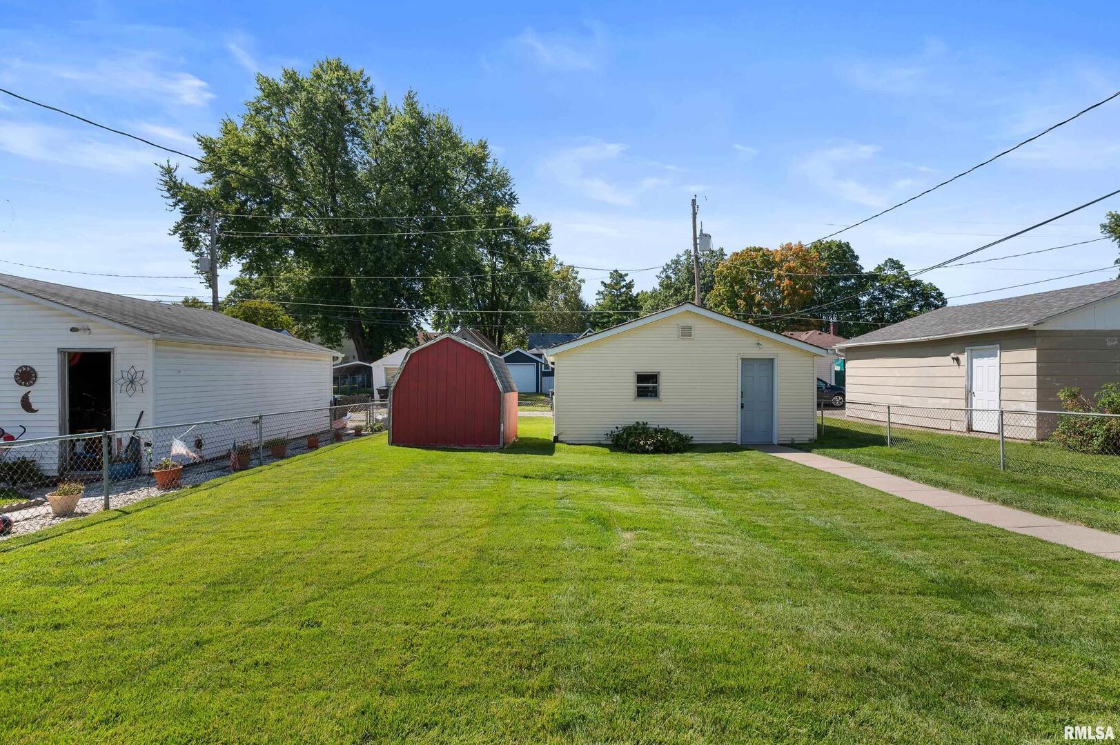 2375 31st Street, Unit A Moline, IL 61265 - Photo 23 of 26 a view of a backyard with potted plants and large tree