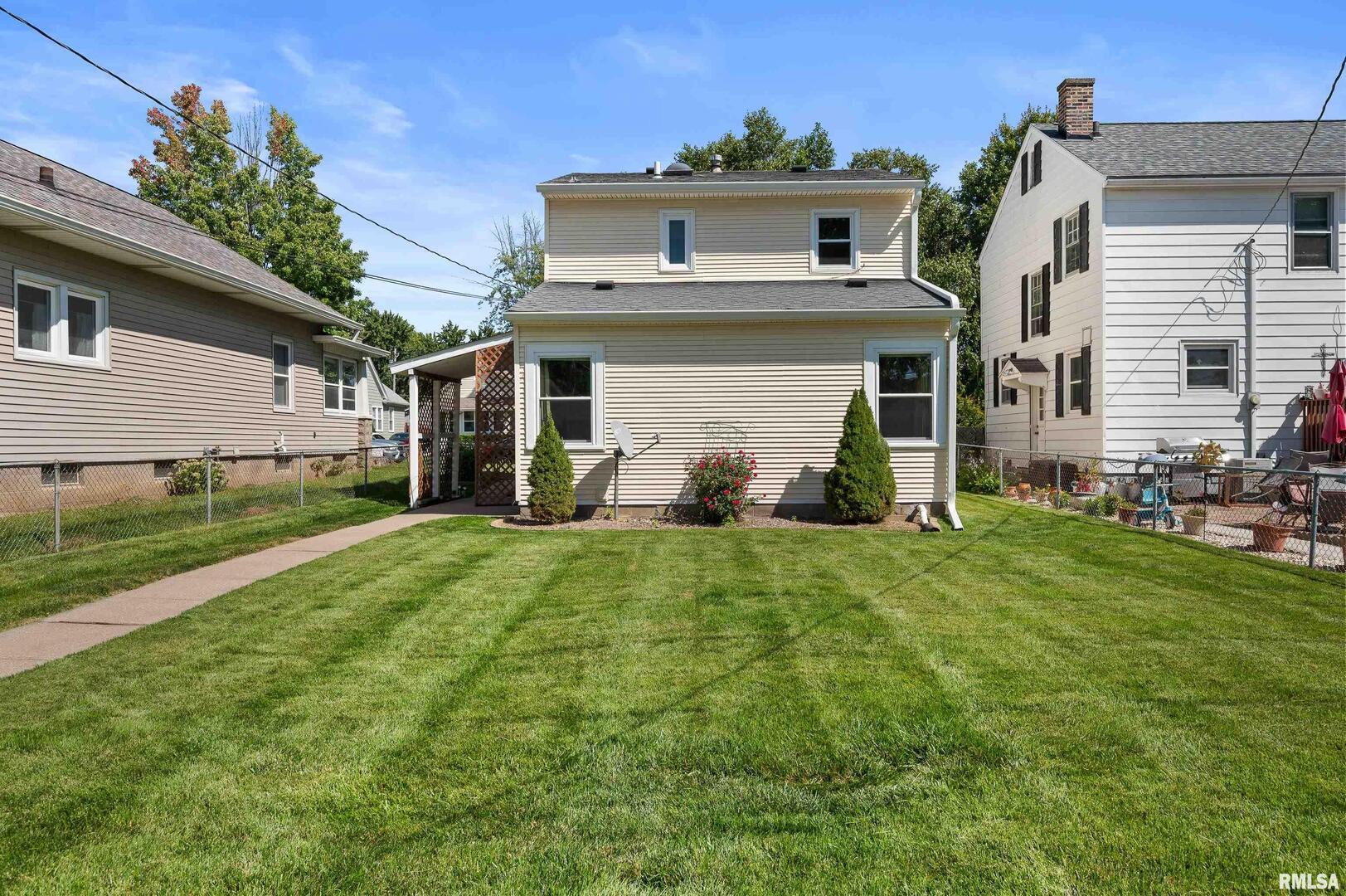 2375 31st Street, Unit A Moline, IL 61265 - Photo 24 of 26 a front view of a house with a yard