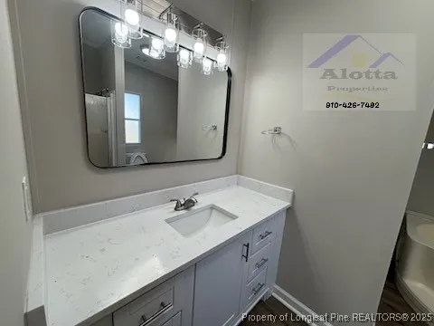 a bathroom with a sink vanity and mirror