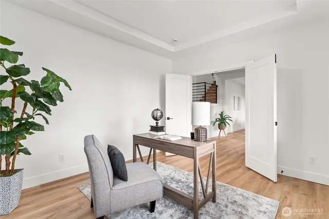 a view of a workspace with furniture and wooden floor