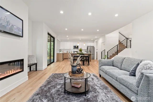 a living room with furniture and kitchen view