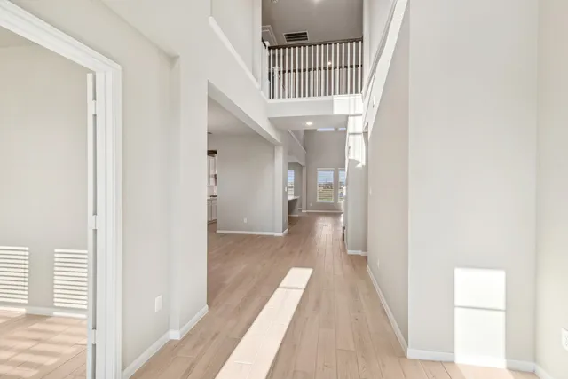 a view of an empty room with a fireplace and a window