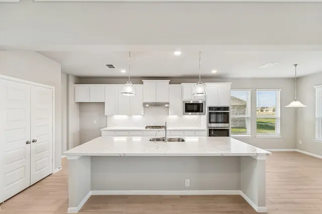 a bathroom with a bathtub a sink and a mirror