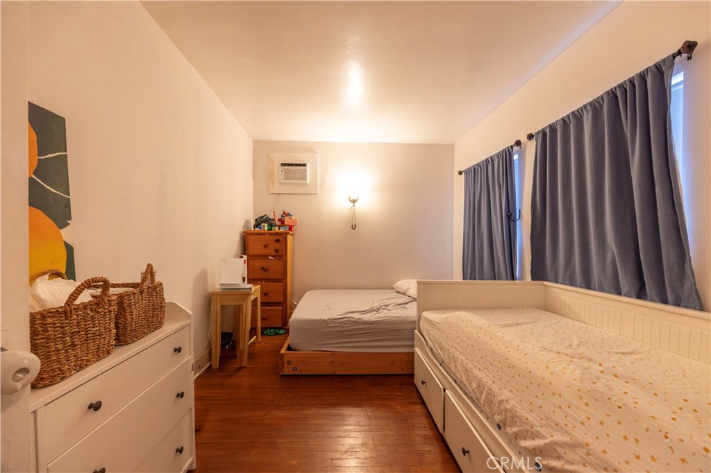 908 Summit Drive South Pasadena, CA 91030 - Photo 11 of 18 a bedroom with a bed and wooden floor