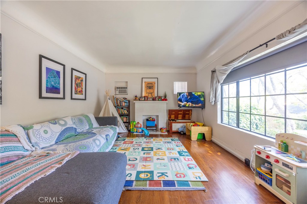 908 Summit Drive South Pasadena, CA 91030 - Photo 8 of 18 a living room with baby crib furniture and a wooden floor