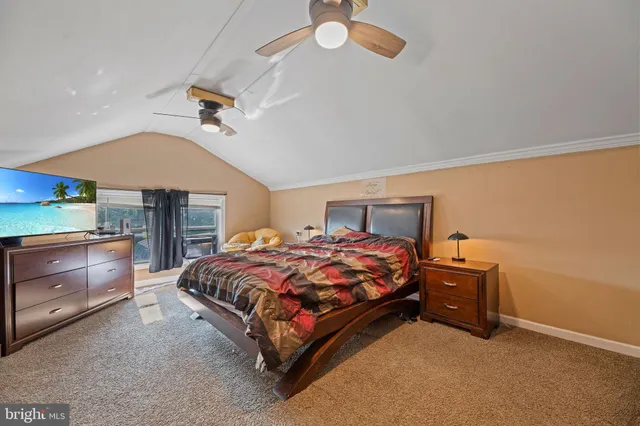 a bedroom with a bed and a ceiling fan
