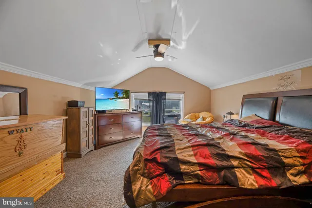 a bedroom with a bed and a tv