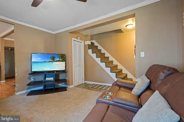 a view of a livingroom with furniture and stairs