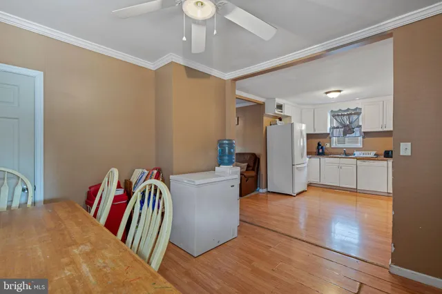 a living room with furniture and kitchen view
