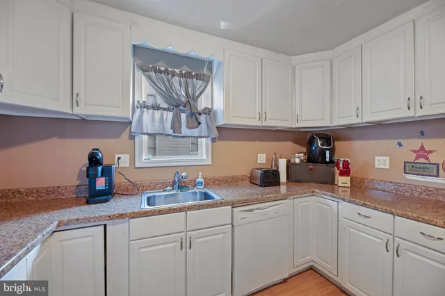 a kitchen with white cabinets and a sink