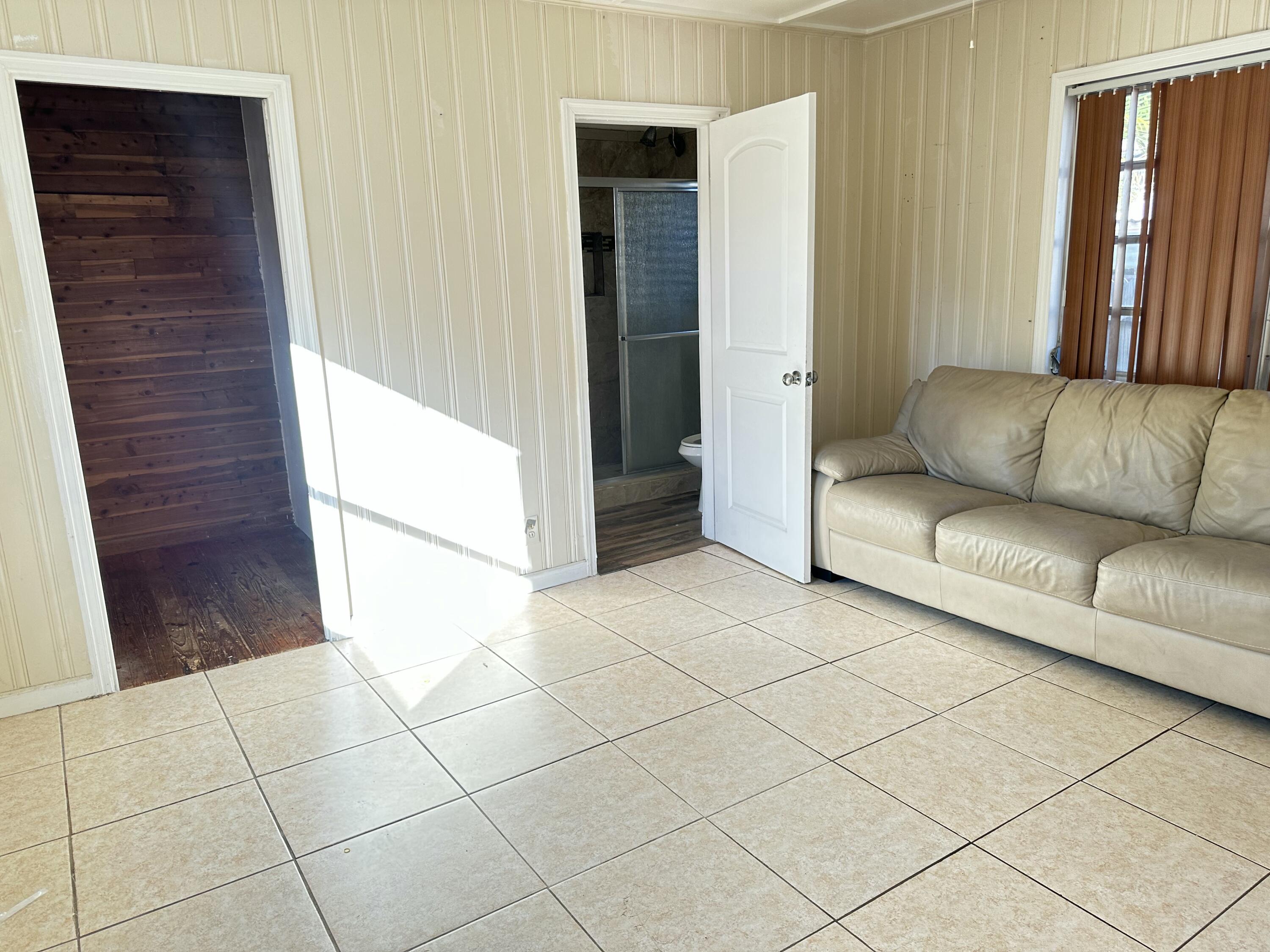 225 Northeast 13th Street Delray Beach, FL 33444 - Photo 17 of 23 a living room with a couch and a walk in closet