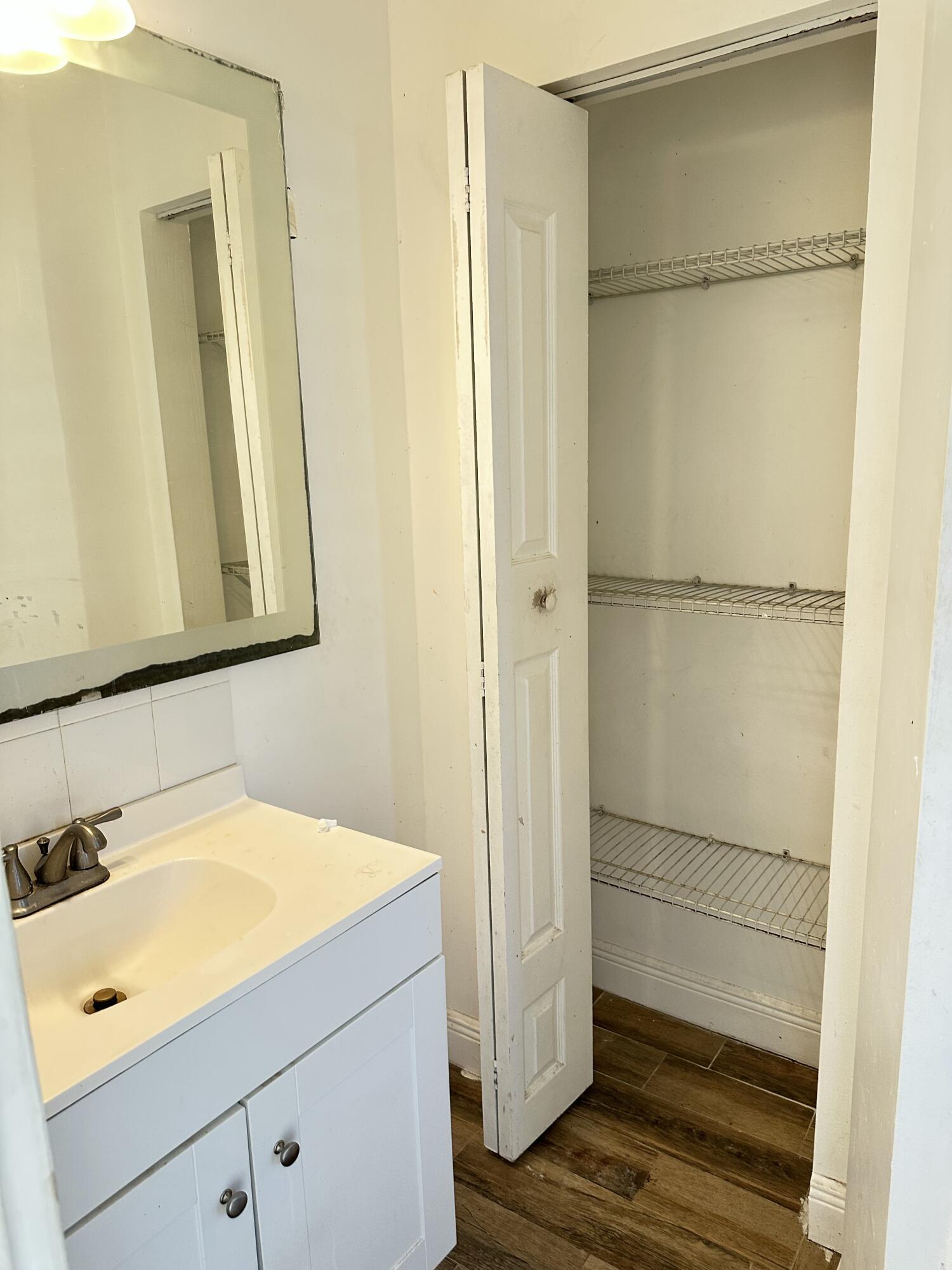 225 Northeast 13th Street Delray Beach, FL 33444 - Photo 18 of 23 a bathroom with a shower sink and mirror