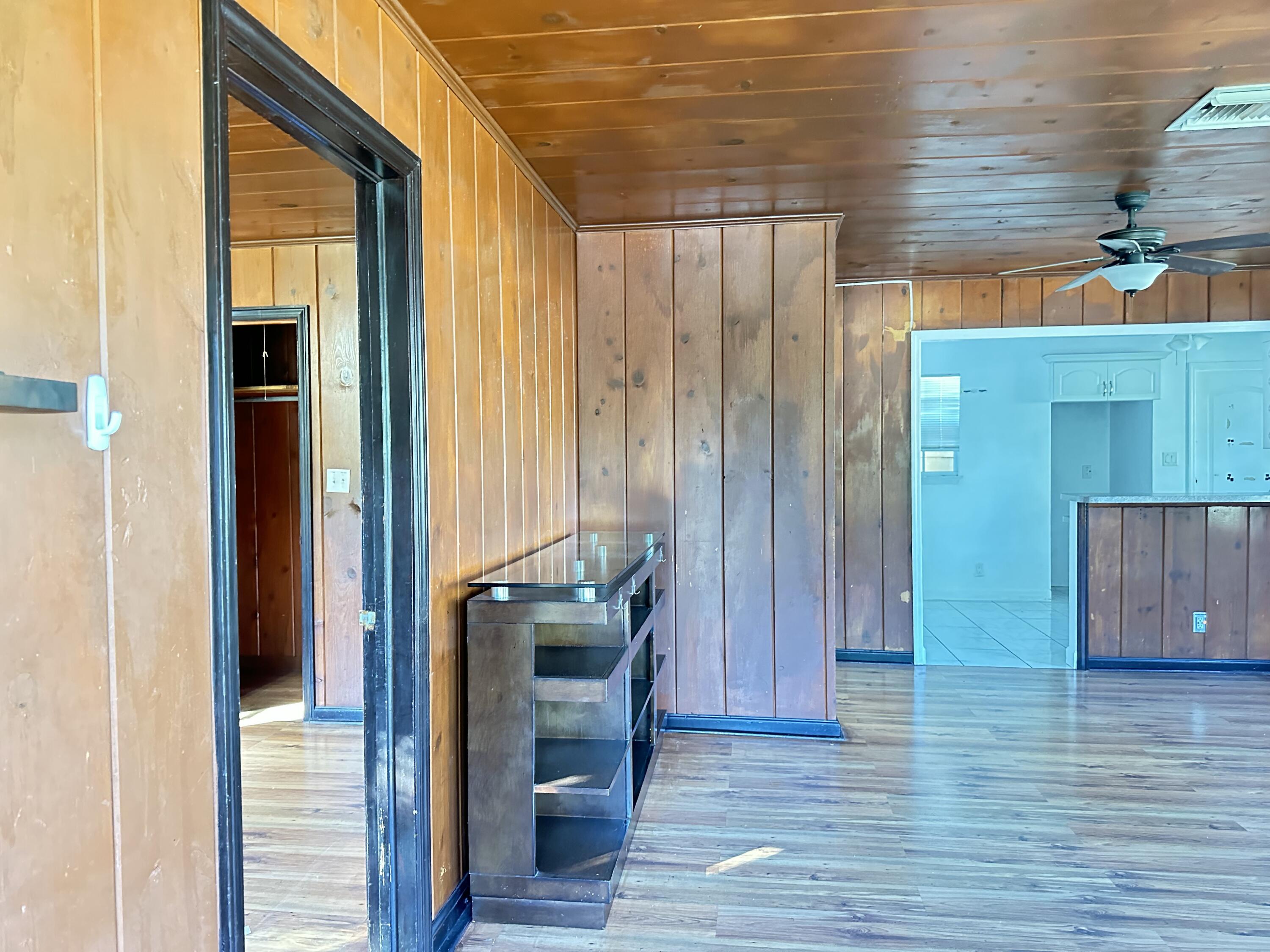 225 Northeast 13th Street Delray Beach, FL 33444 - Photo 7 of 23 a view of front door with hallway and wooden floor