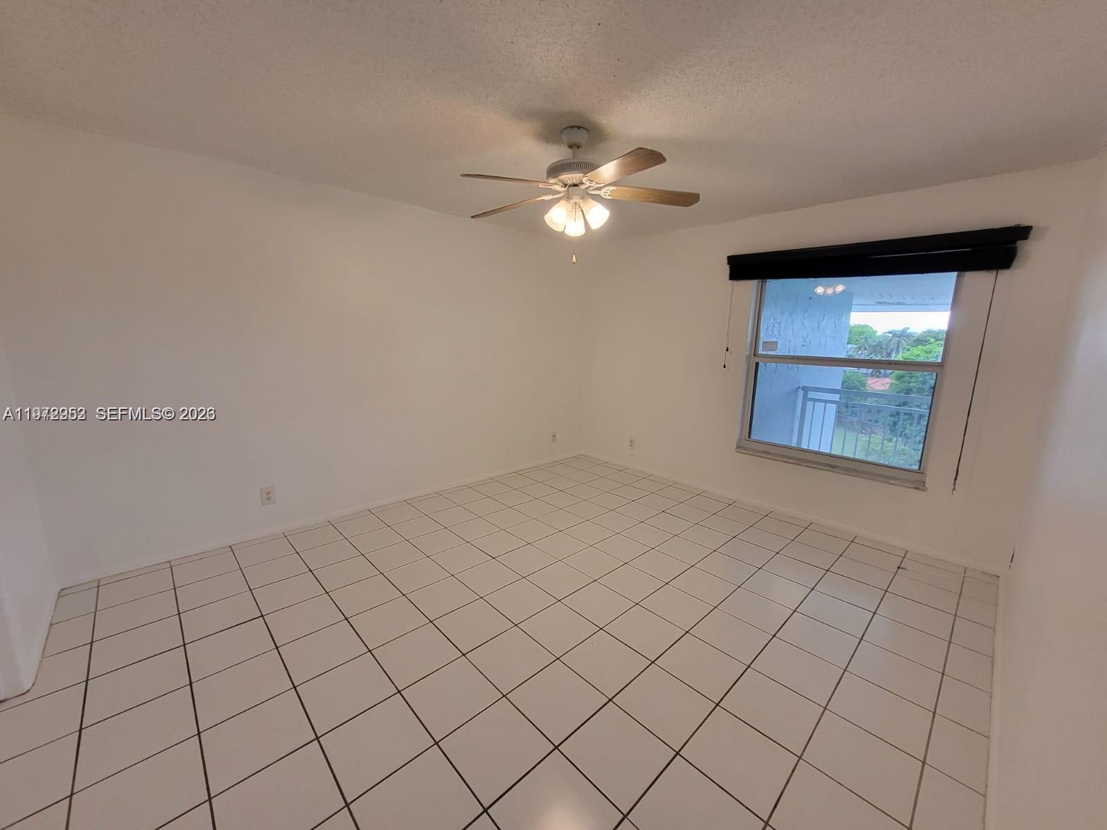 455 South Pine Island Road, Unit 410C Plantation, FL 33324 - Photo 12 of 35 an empty room with windows and fan