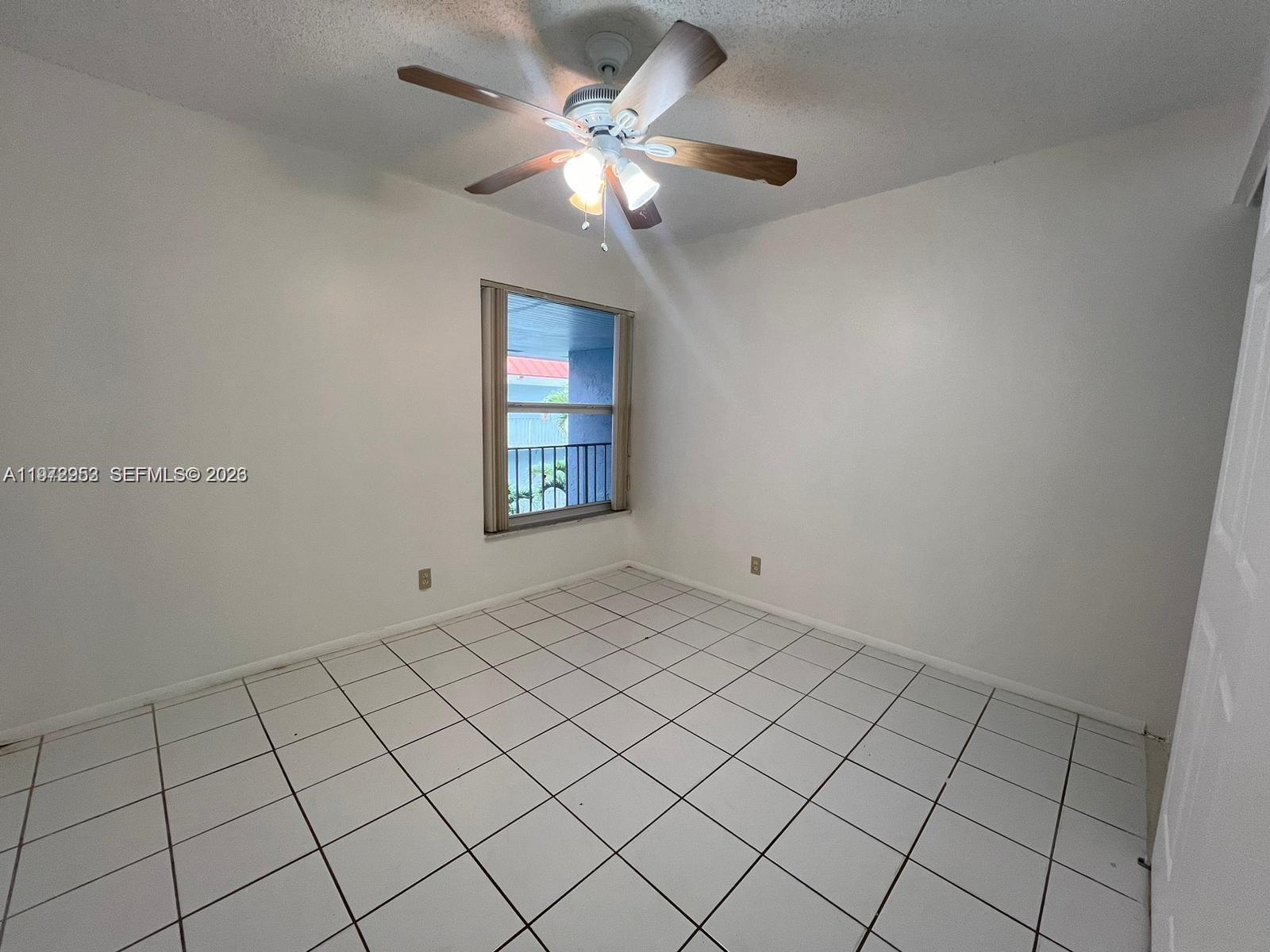 455 South Pine Island Road, Unit 410C Plantation, FL 33324 - Photo 22 of 35 a view of an empty room and a chandelier fan