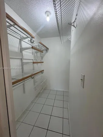 a bathroom with a granite countertop sink a toilet and bathtub