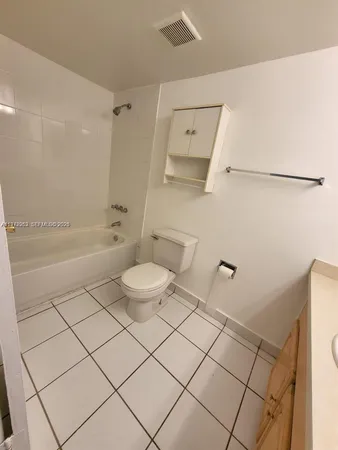 a bathroom with a sink a toilet and bathtub