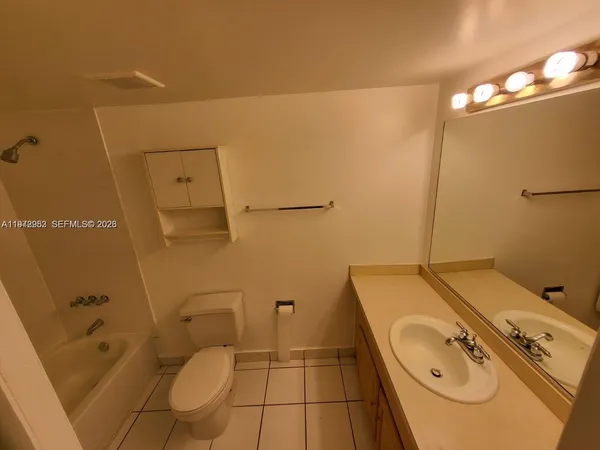 a bathroom with a toilet a sink and bathtub