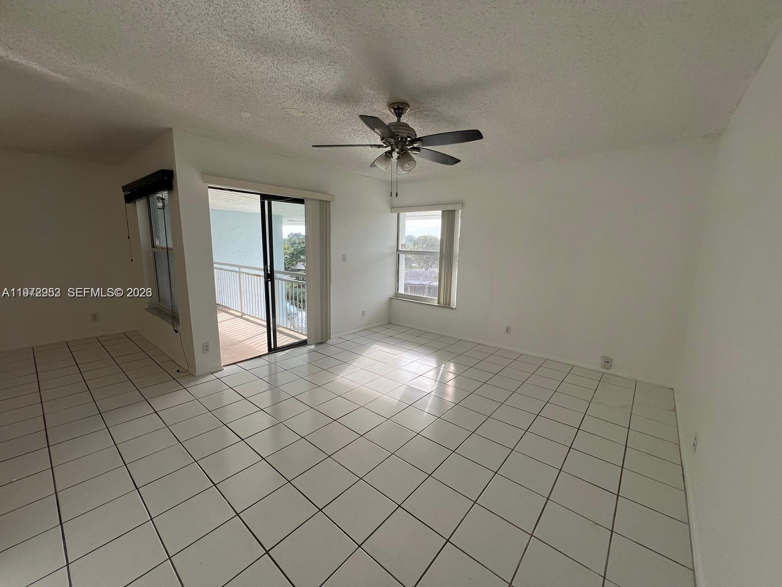 455 South Pine Island Road, Unit 410C Plantation, FL 33324 - Photo 30 of 35 an empty room with windows and ceiling fan