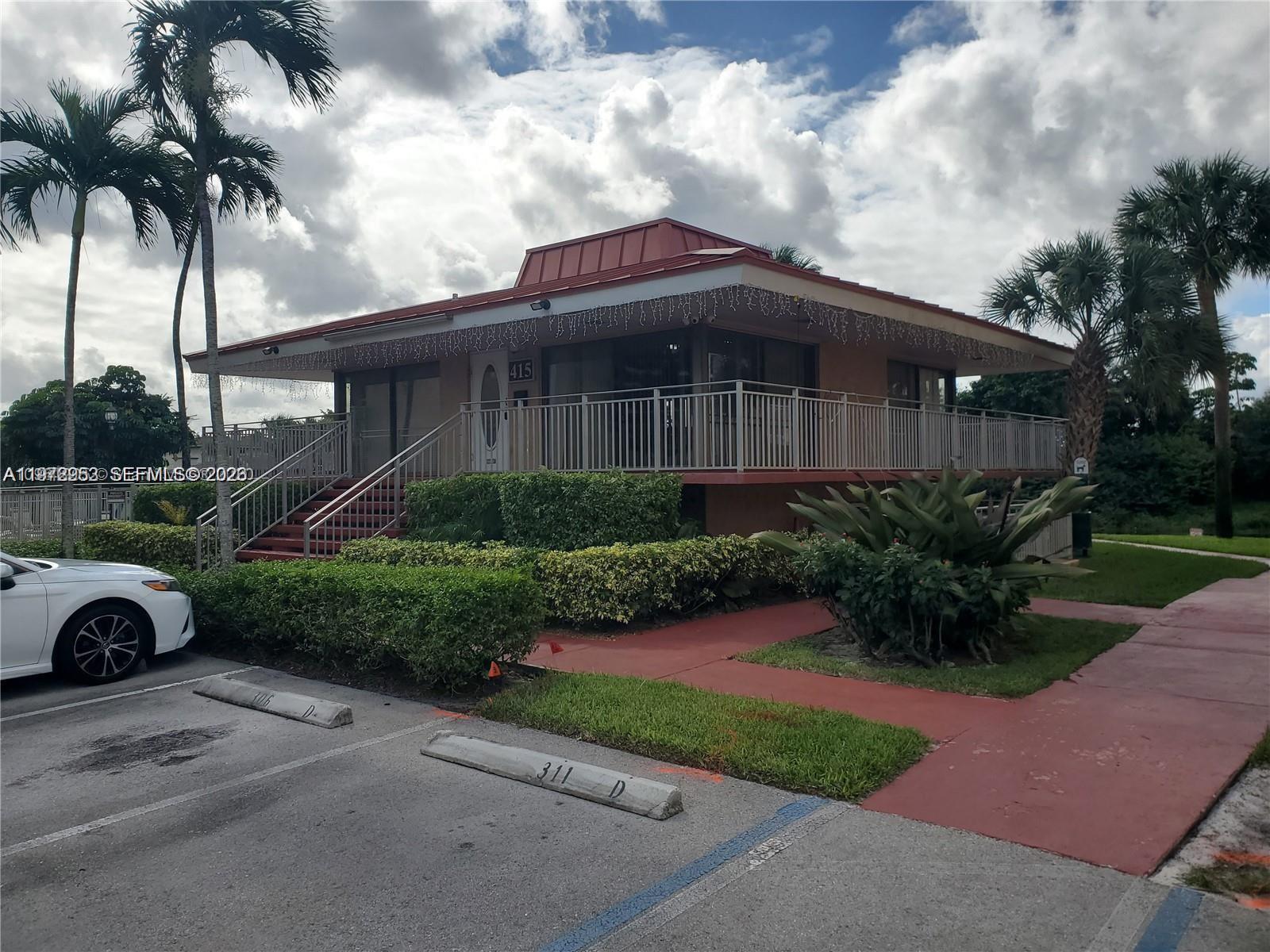 455 South Pine Island Road, Unit 410C Plantation, FL 33324 - Photo 5 of 35 a front view of a house with a garden and trees