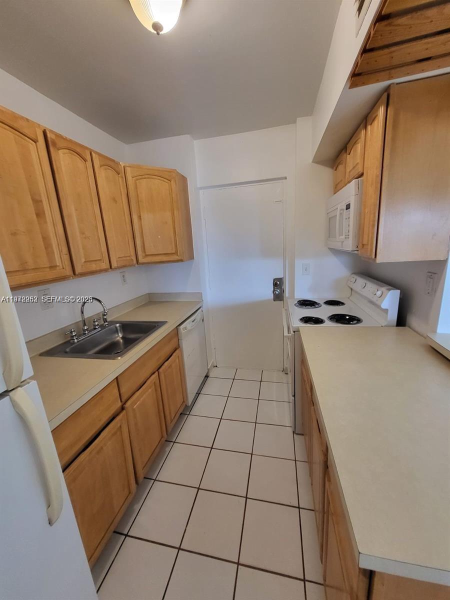 455 South Pine Island Road, Unit 410C Plantation, FL 33324 - Photo 7 of 35 a kitchen with a sink a stove top oven and cabinetry