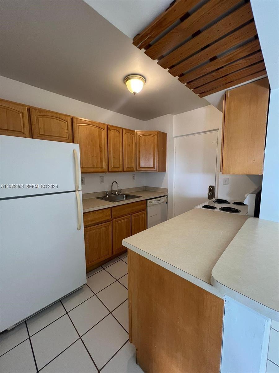 455 South Pine Island Road, Unit 410C Plantation, FL 33324 - Photo 8 of 35 a kitchen with stainless steel appliances a refrigerator sink and cabinets