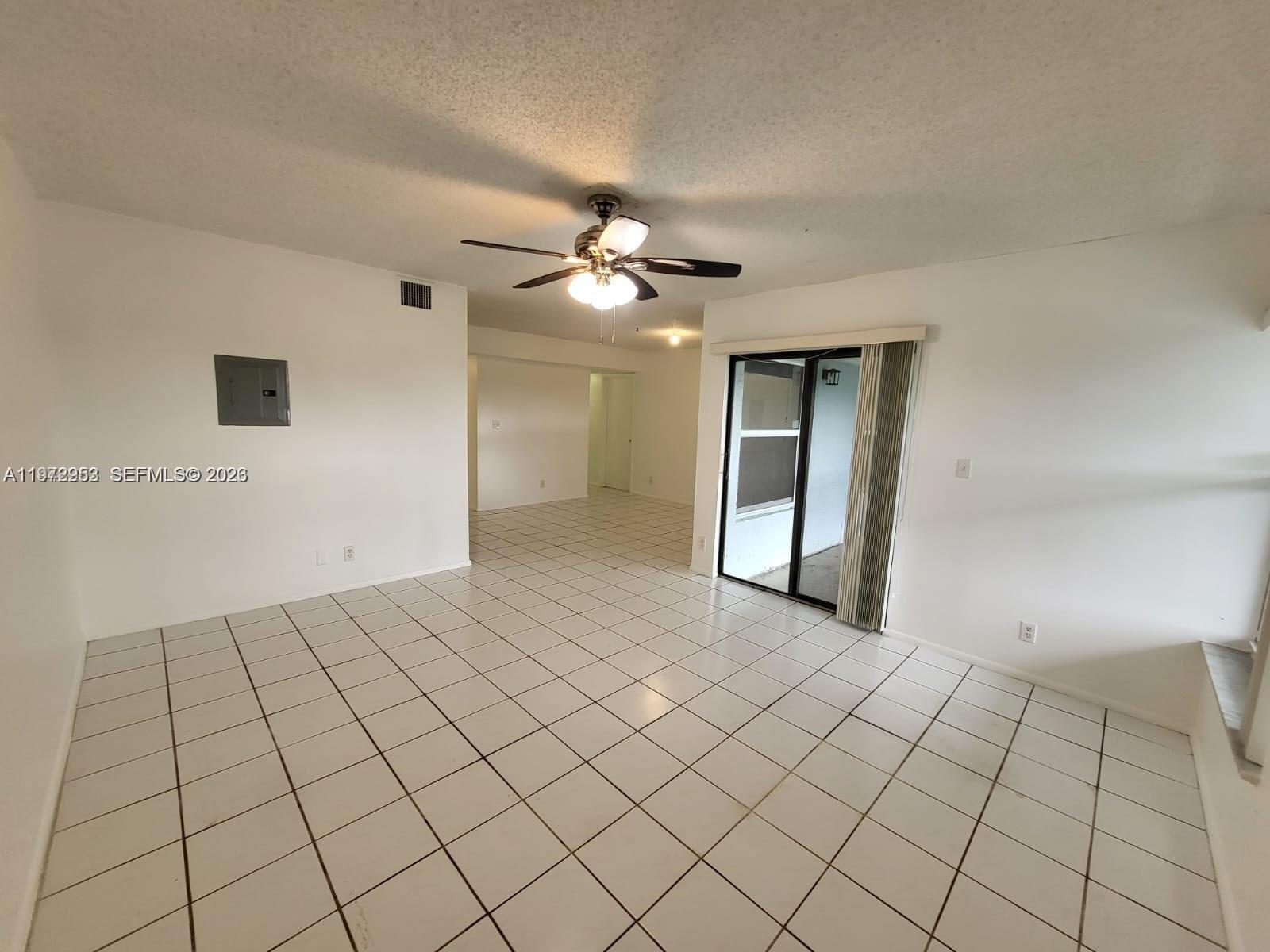 455 South Pine Island Road, Unit 410C Plantation, FL 33324 - Photo 10 of 35 a view of an empty room and chandelier fan