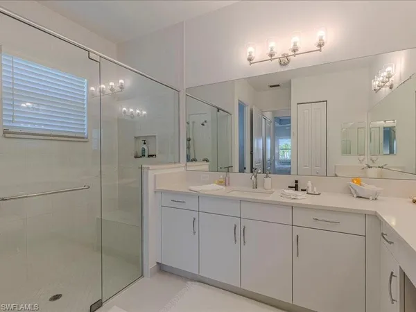 a bathroom with double sink and a mirror